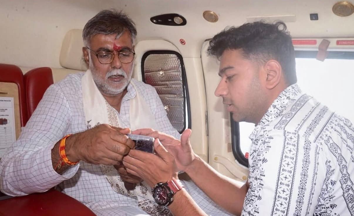Reviewing campaign content with Prahlad Singh Patel mid-flight
